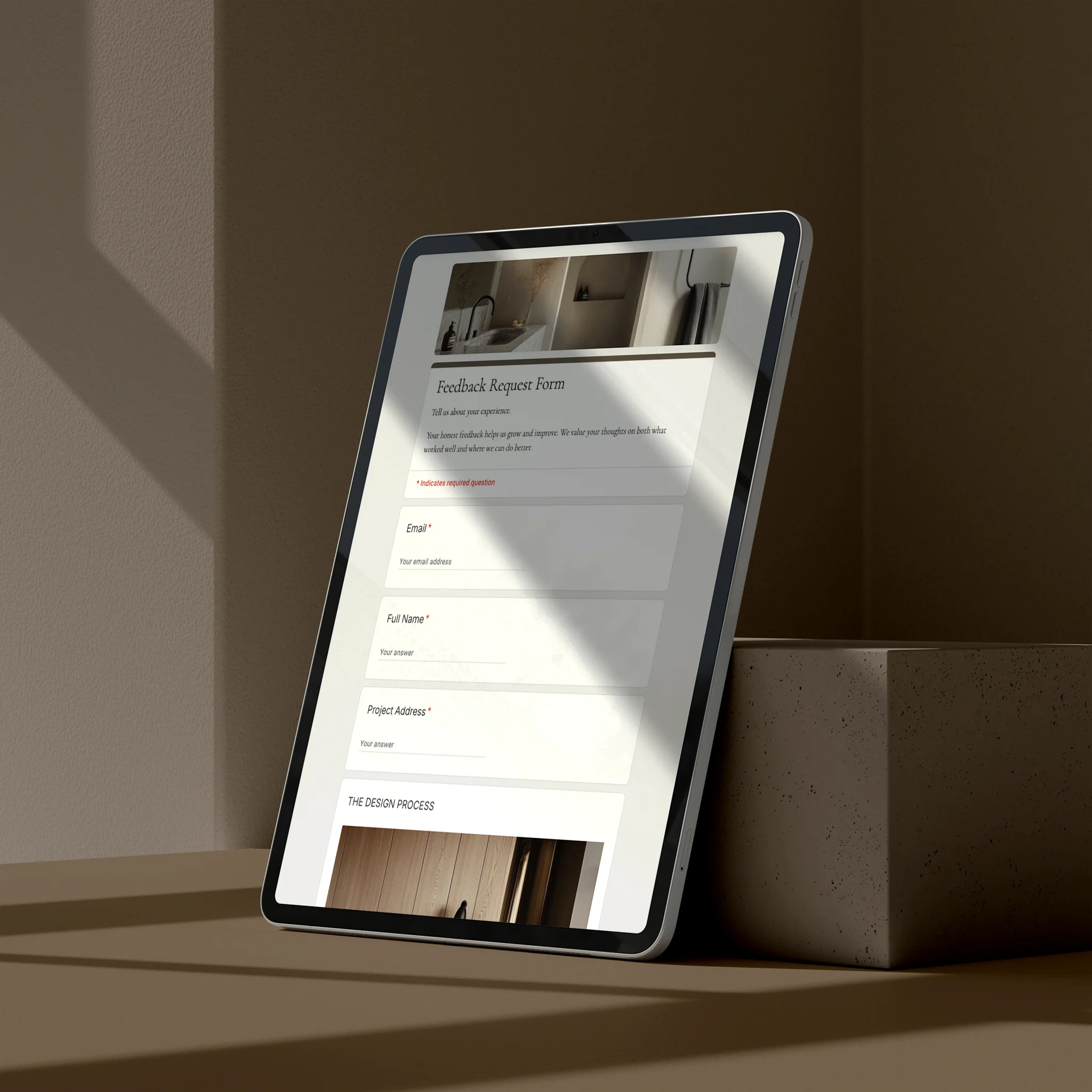 Tablet displaying client feedback request form on a brown surface with a neutral background