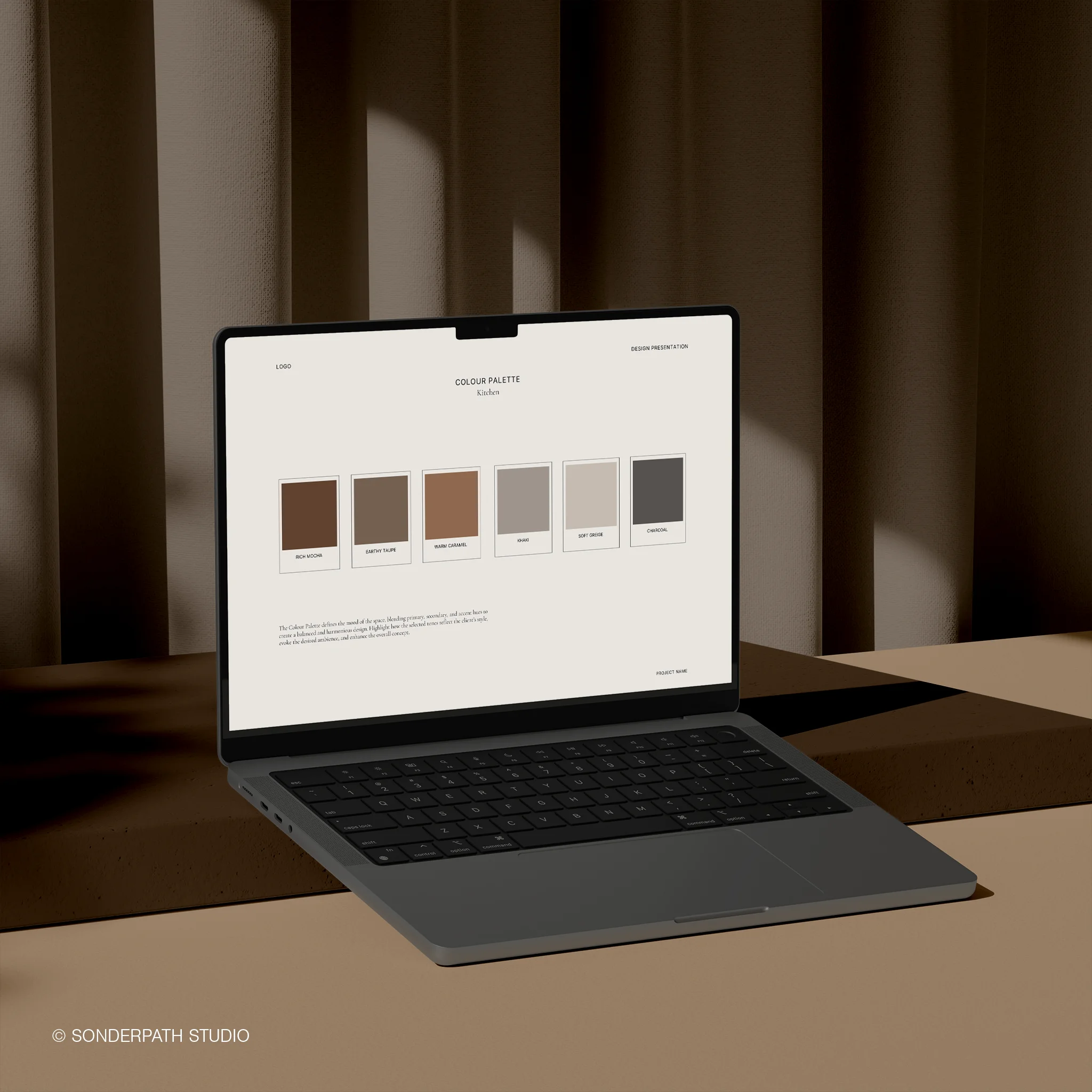 Laptop displaying a color palette on a brown surface with a brown curtain background