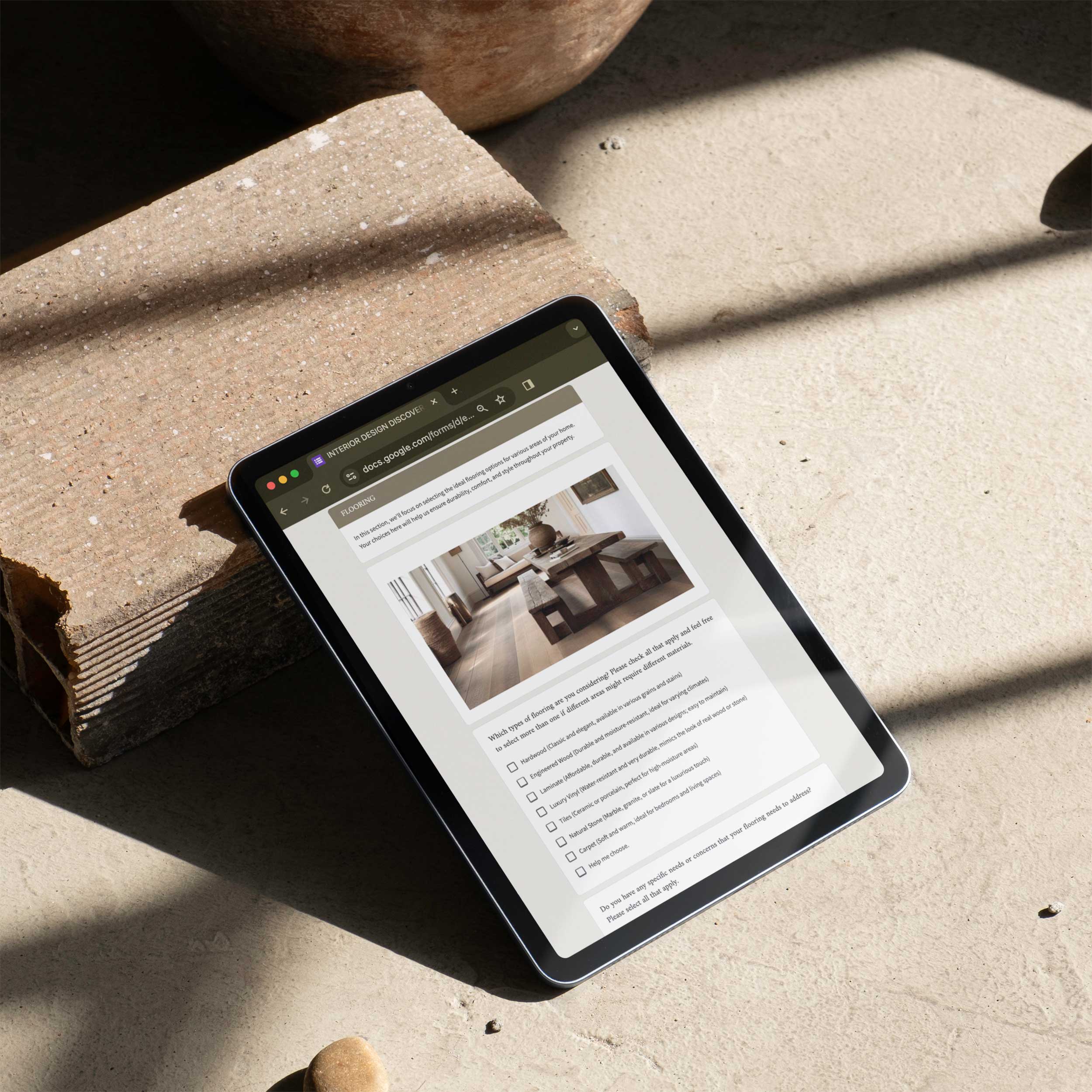 Design Discovery Questionnaire template for interior designers shown on tablet with natural light. Editable in Canva and Google Docs.