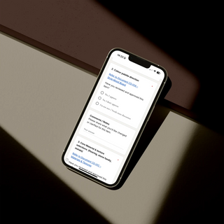 Smartphone displaying a page of the client feedback and sign-off checklist template on a dark surface