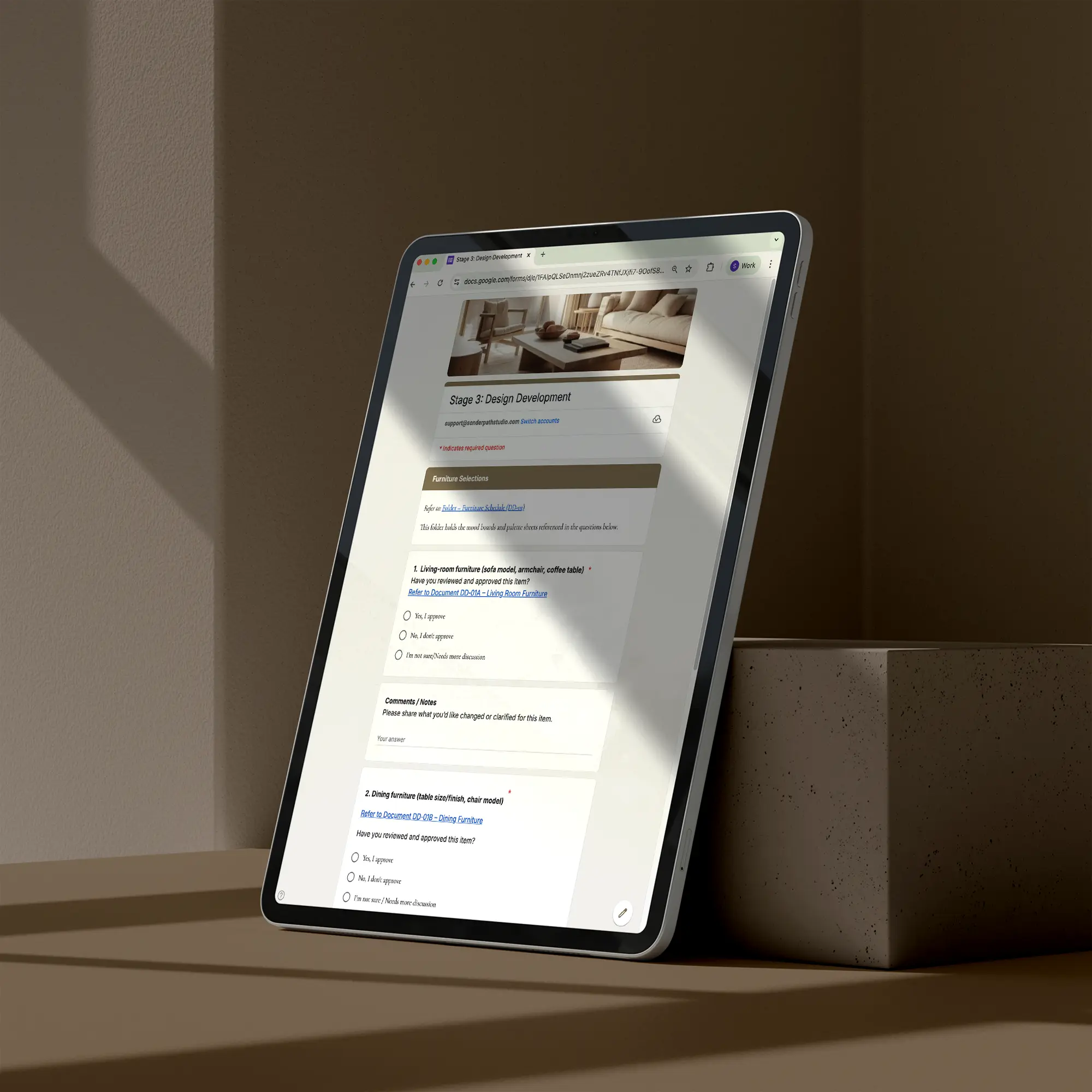 Tablet displaying a webpage on a dark surface with a neutral background featuring a page of the client feedback and sign-off checklist template for interior designers