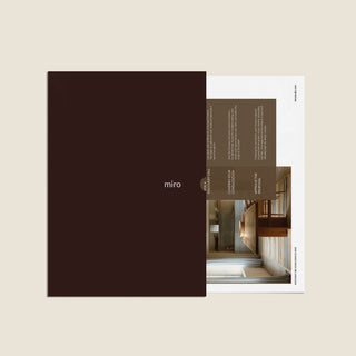 Miro product packaging with a black cover and interior pages showing architectural images.