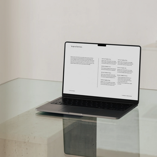 fee proposal template scope of services page shown in laptop on a glass table. 